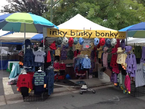 The Inky Binky Bonky tent full of stamped clothes and hats at an outdoor market